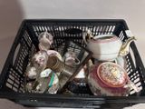 a black basket filled with tea pots and tea cups