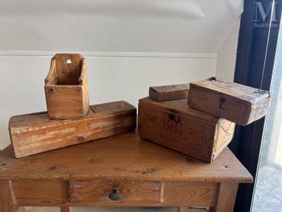 two wooden boxes sitting on a table next to each other