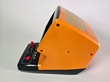 an orange and black electronic device on a white surface
