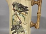two birds sitting on a branch on this coffee mug