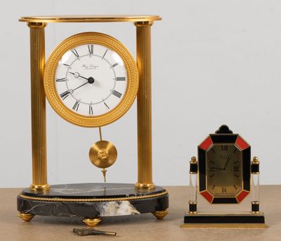 a clock that is sitting on a table next to a small clock
