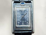 a silver watch with a blue face on a black strap