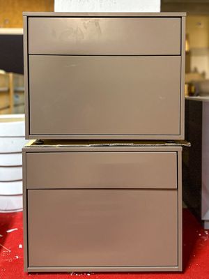 three boxes stacked on top of each other on a red table