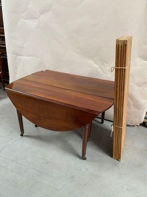 a small wooden table with a wooden post on it