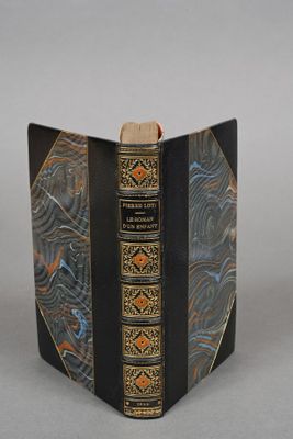 a black book with a gold and blue design on it