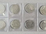 six different types of coins in plastic bags on a white surface