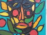 une image représentant un tableau représentant le visage d'un homme sur fond bleu
