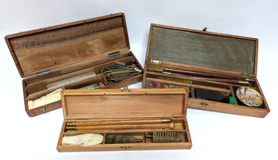 three wooden boxes with different types of items in them