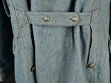 a close up of a coat with buttons on it