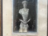 an old photo of a woman wearing a tiara and a dress