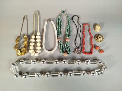 a lot of different necklaces and bracelets on the table