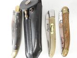 several different types of knives are lined up on a white surface