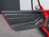a close up of a red car door with the door open