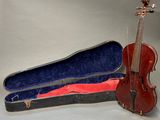 a violin and a violin case sitting on a table