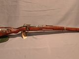 un vieux fusil avec un canon en bois et des accessoires en laiton