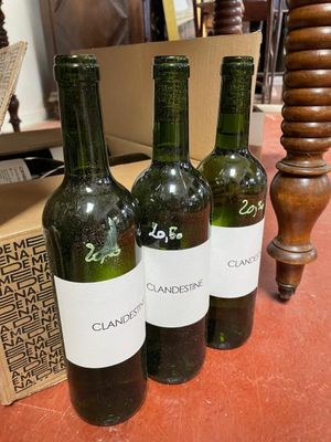 three bottles of wine sitting on a table next to a box of wine