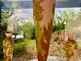 three vases sitting on a window sill in front of a window