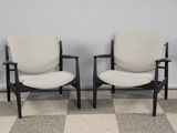 two chairs sitting next to each other on a checkered floor