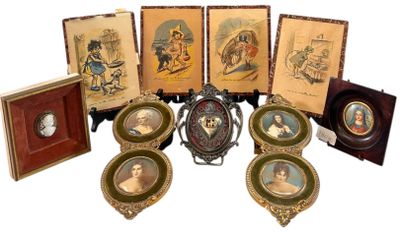 a group of framed pictures of people on a table
