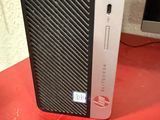 the computer is sitting on a red surface next to a mouse