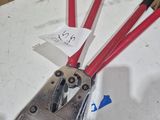 four red and black hand tools on a white table