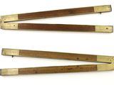 three wooden rulers are lined up on a white surface