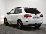 the rear end of a white suv parked in a room