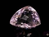 an image of a pink diamond sitting on top of a black surface