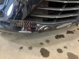a close up of a car ' s grille with a sticker on it