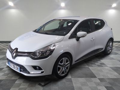 the white car is parked on a checkered tile floor