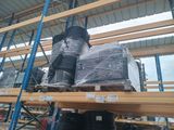 many stacks of black plastic cups on a shelf