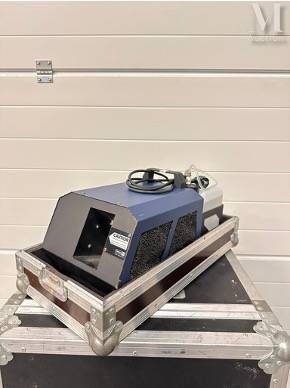 a blue and black machine sitting on top of a case