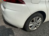 a white car that is parked on the side of the road