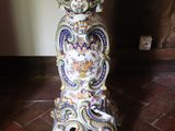 a table with a vase on top of it on a tiled floor