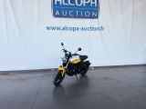 a motorcycle that is parked in front of a sign