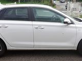 a white car that is parked in a parking lot