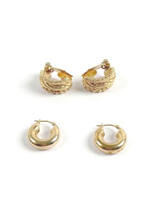 two pairs of gold toned hoop earrings and a pair of gold toned hoop earrings