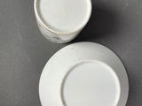 two cups and a saucer sitting on a table