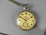a yellow pocket watch with a chain around it