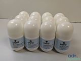 six bottles of white deodorant sitting on a table