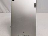 the back of a silver tablet computer sitting on top of a white surface