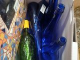 a box full of blue bottles and a green bottle in it