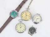 four different types of watches sitting on a white surface