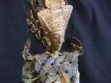 a statue of a woman with a basket on her head and a hat on her head