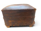 an old wooden box that is sitting on a white surface