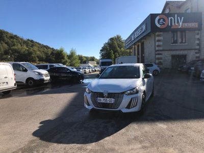 the white car is parked in front of the building in the parking lot