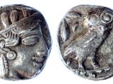 a close up of two silver coins on a white surface