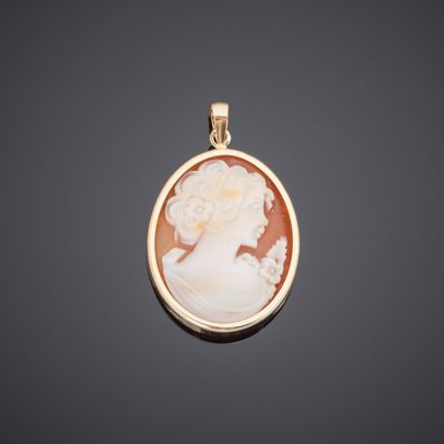 a gold and cameo cameo pendant with a woman ' s profile