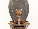 a wooden object that is sitting on top of some books