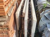 a pile of bricks sitting next to a pile of pipes